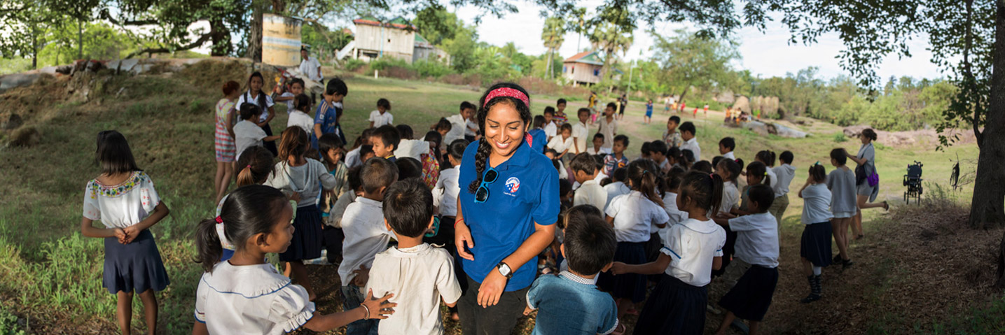 A Peace Corps participant volunteers with children while on a program