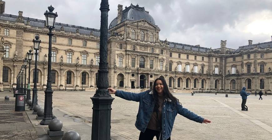 UC Merced student posing in the courtyard of the Louvre, Paris, France